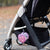 Cutie Clasp attached to a stroller holding a snack container.