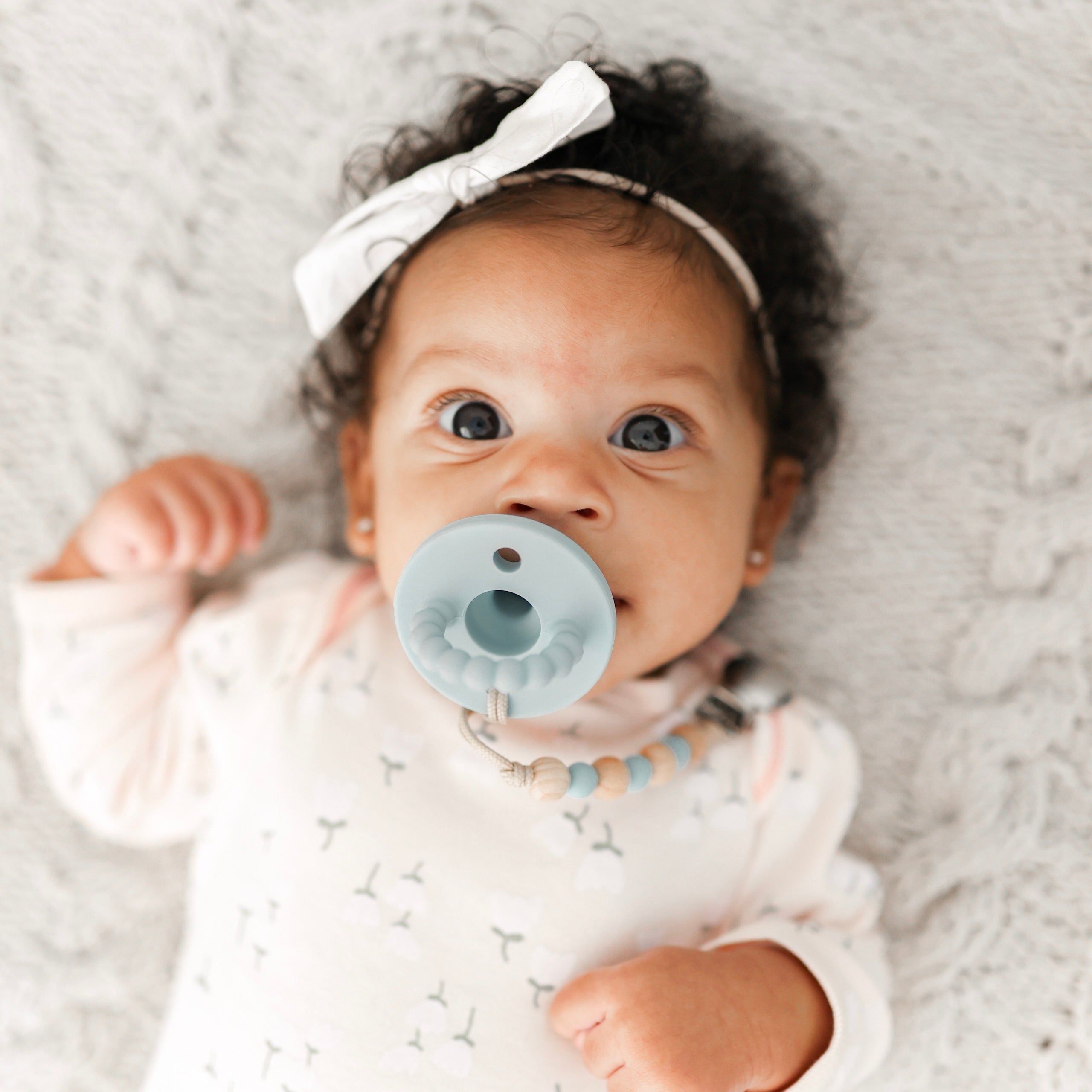 Baby sucking on a pacifier 