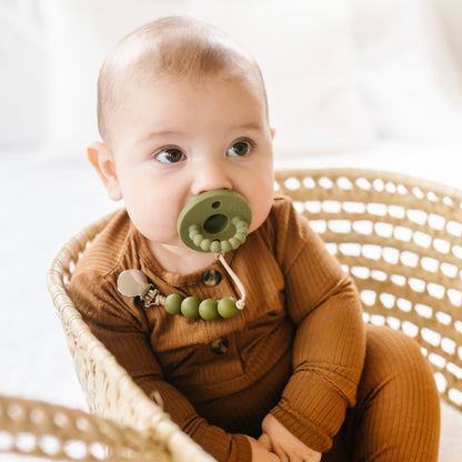 Baby sucking on a pacifier 