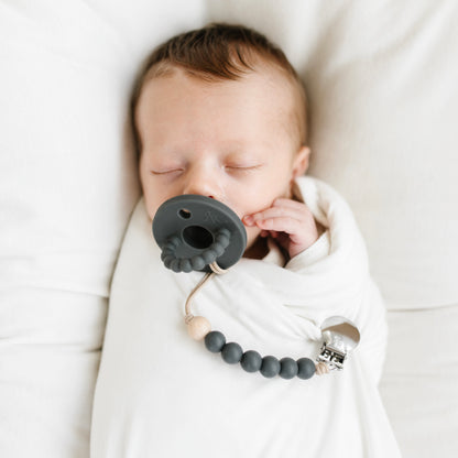 Baby sucking on a pacifier 