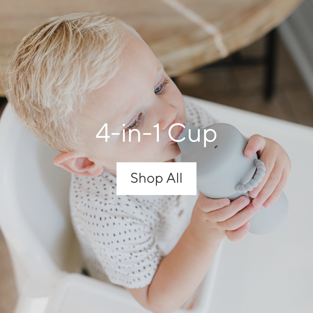 Toddler drinking out of a Cutie Cup.