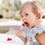 Girl eating raspberries using Cutie Tensils.