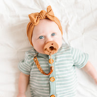 Baby using a Lotus Cutie Clip attached to a Cutie PAT Round.