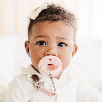 Baby girl wearing a Blush Cutie PAT and Quinn Cutie Clip.