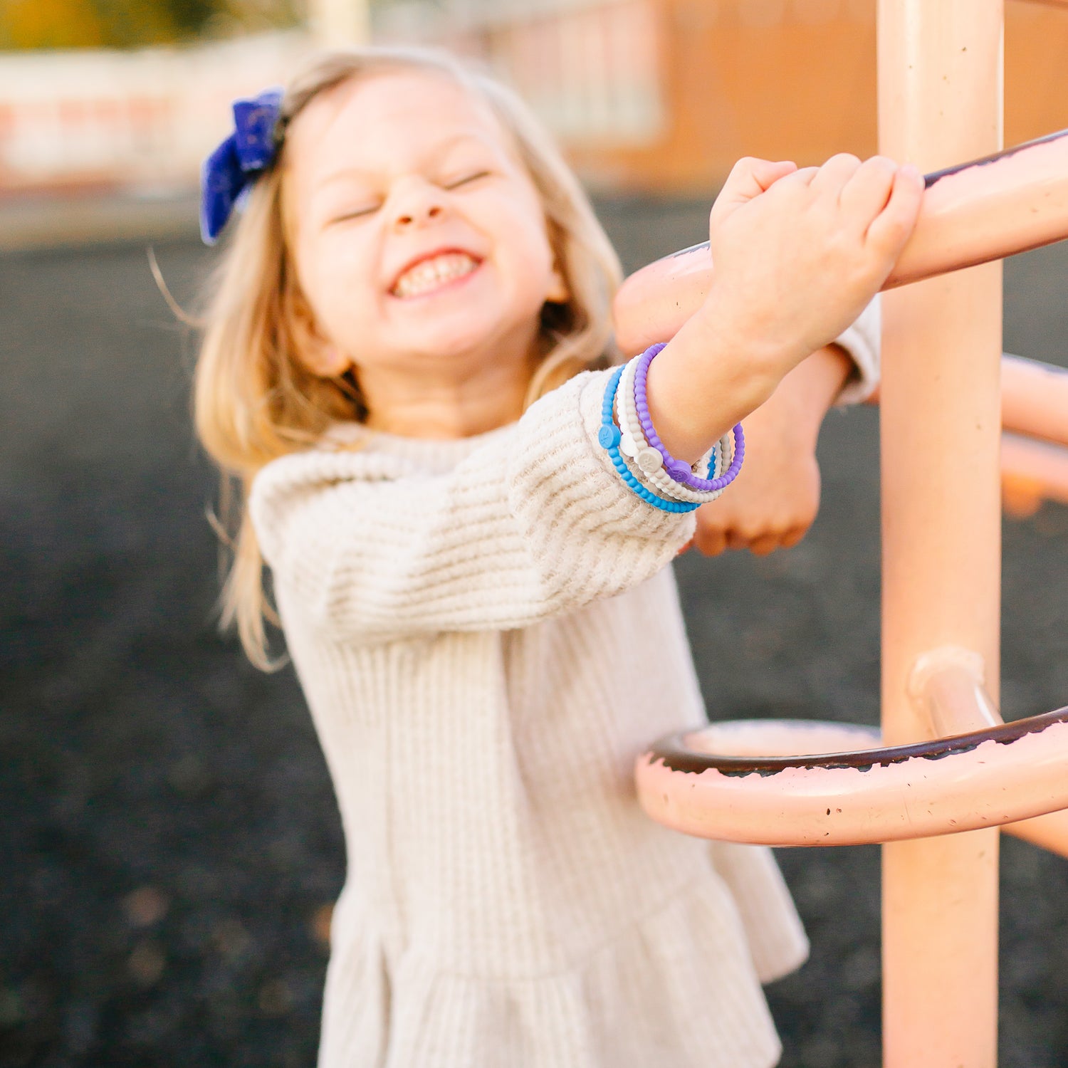 Girl playing at the park wearing the Fall 2019 Cutie Bracelets.