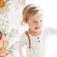 Baby wearing a Flynn Cutie Clip attached to a Cutie PAT.