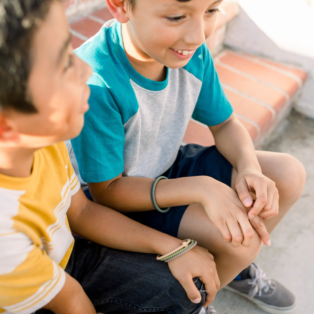 Two boys wearing the Camo Cutie Bracelets.
