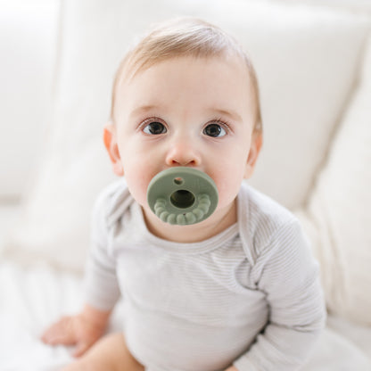 Baby sucking on a pacifier 