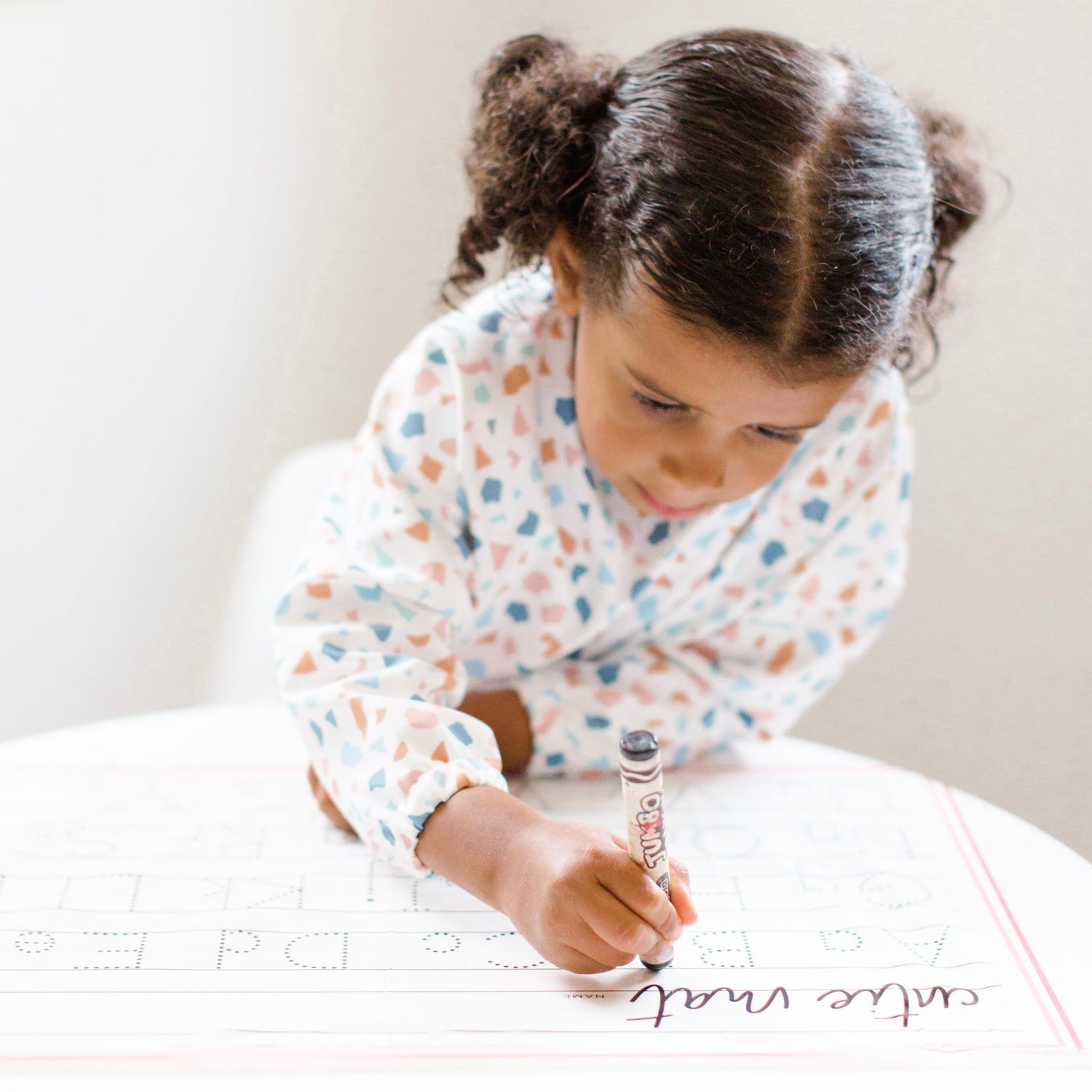 Girl tracing on the Cutie Mat.