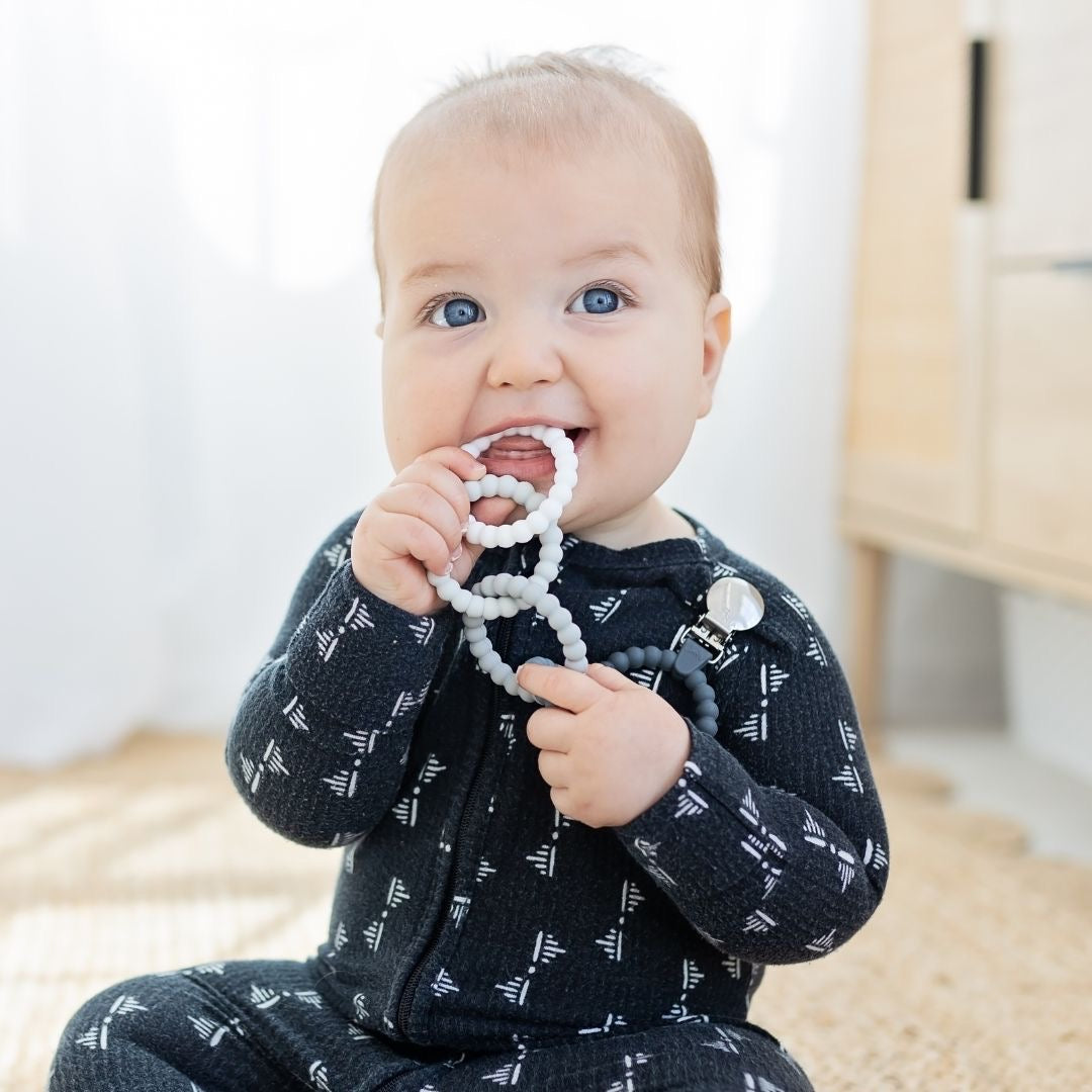 Baby boy playing with the Alloy Cutie Clinks.