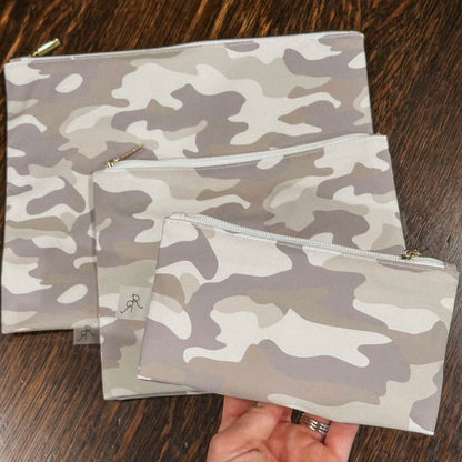 Set of camouflage pouches on a wooden surface