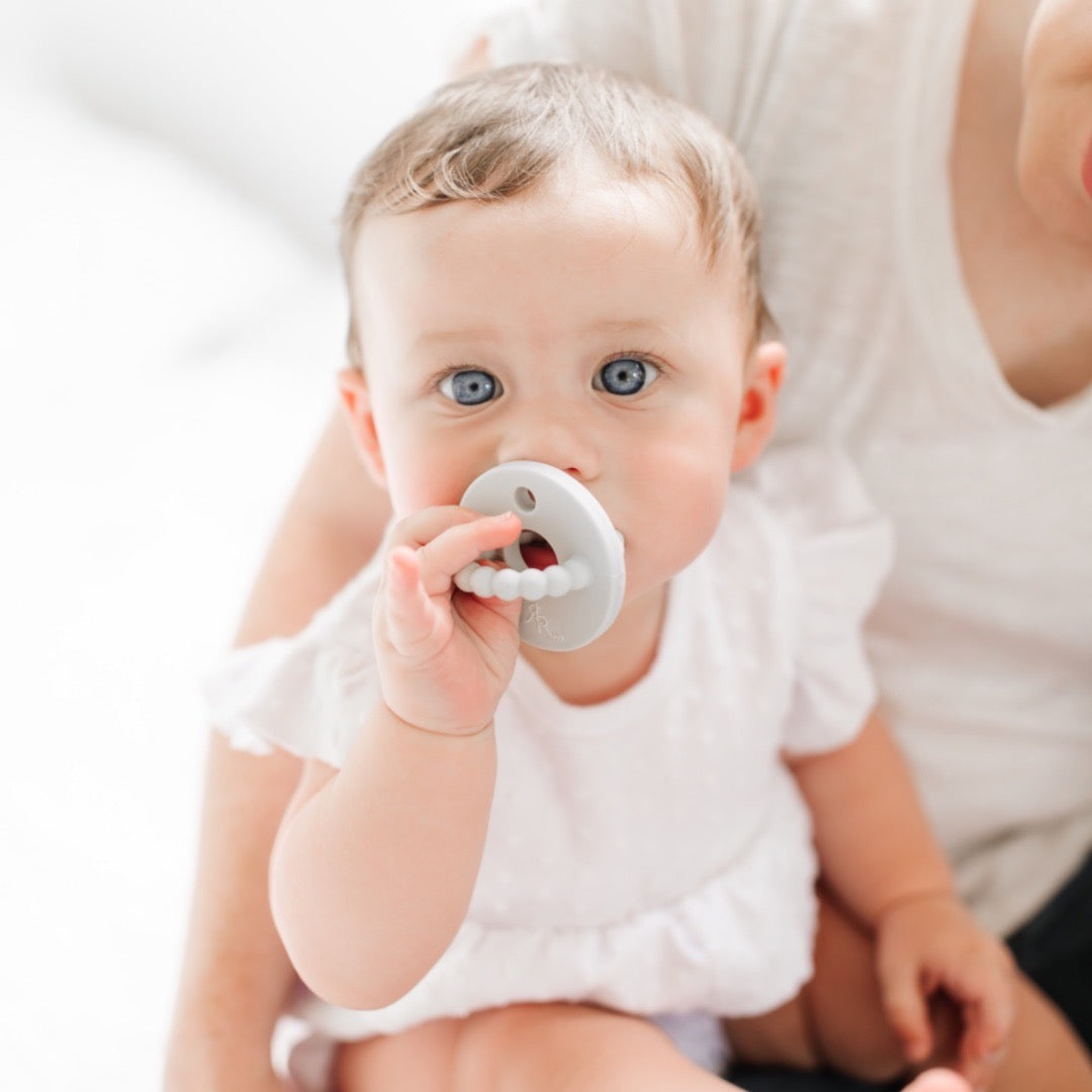 Baby teething on the Grey Cutie Bit.