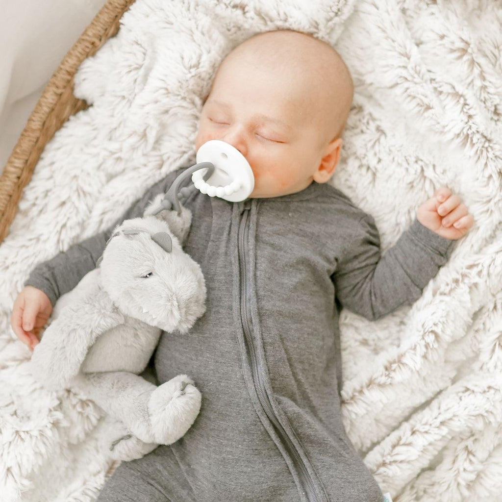 Baby using a White Cutie PAT attached to a Dino Grey Cutie Cuddle.