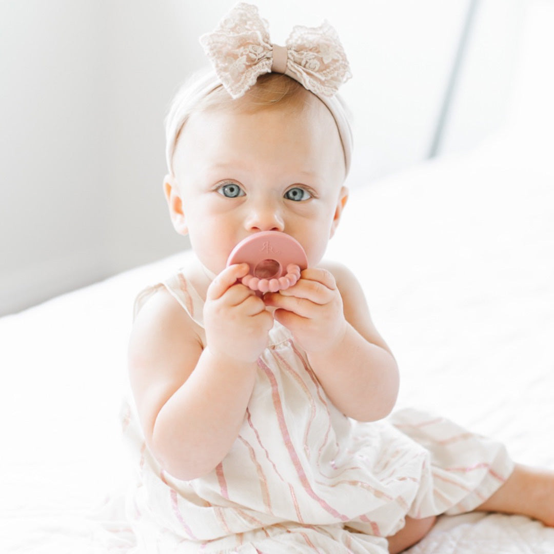 Baby teething on the Rose Cutie Bit.