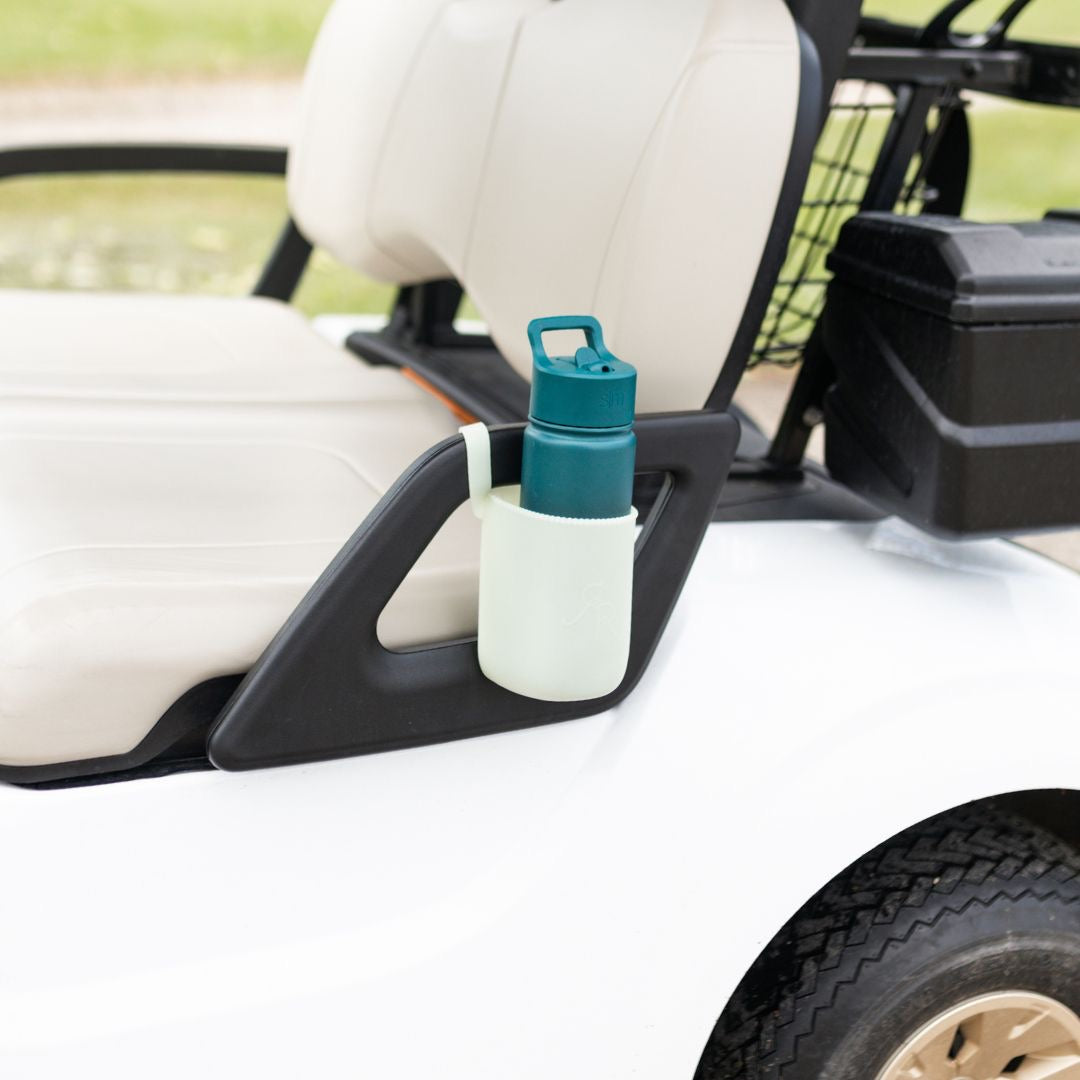 Cutie Holder attached to a golf cart holding a water bottle.