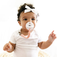 Baby using a Finn Peachy Cutie Clip attached to a Cutie PAT Flat.