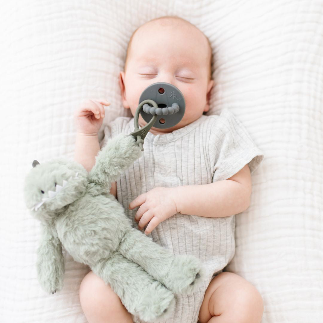 Baby using a Steel Cutie PAT attached to a Dino Green Cutie Cuddle.