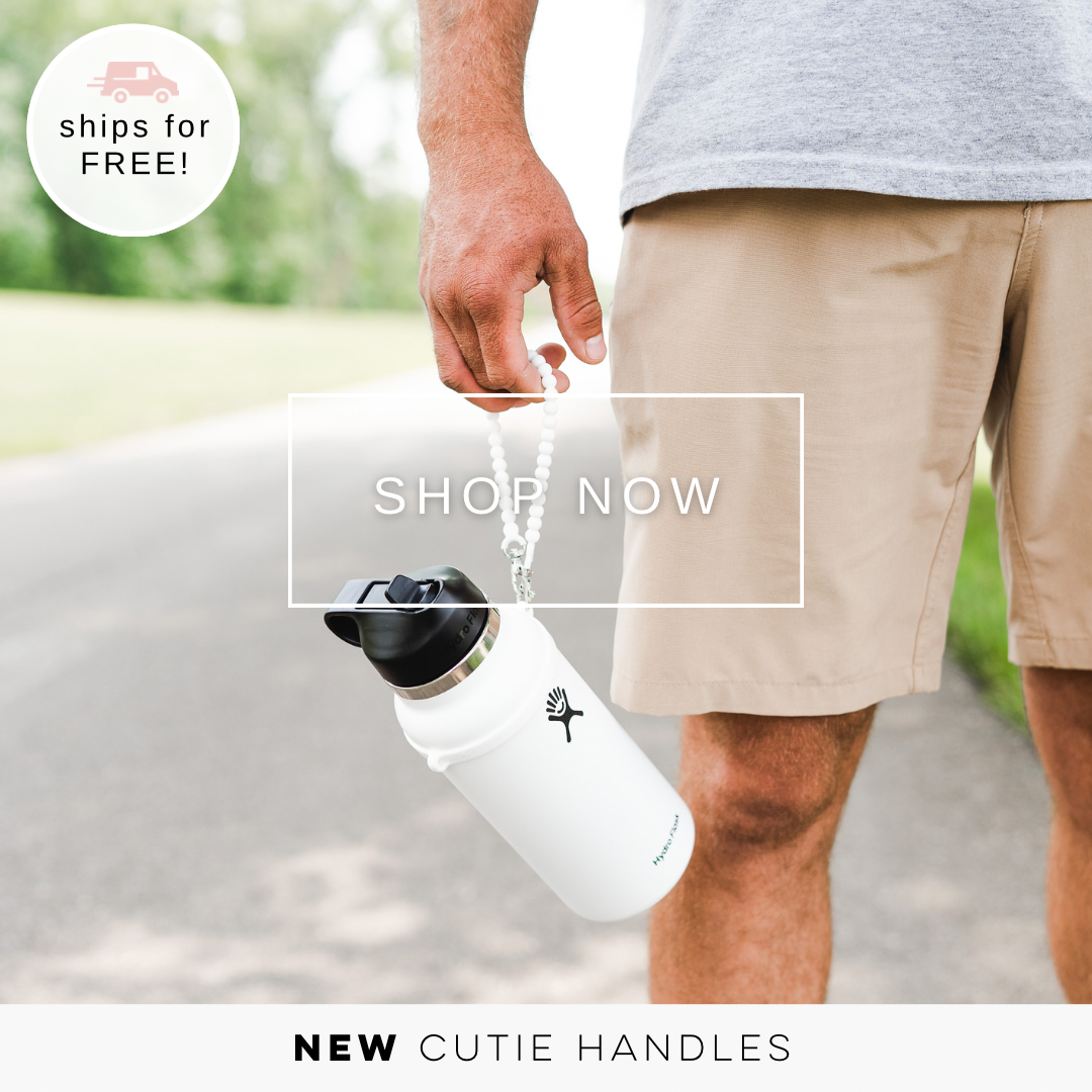 Man holding Cutie Handle attached to a water bottle.