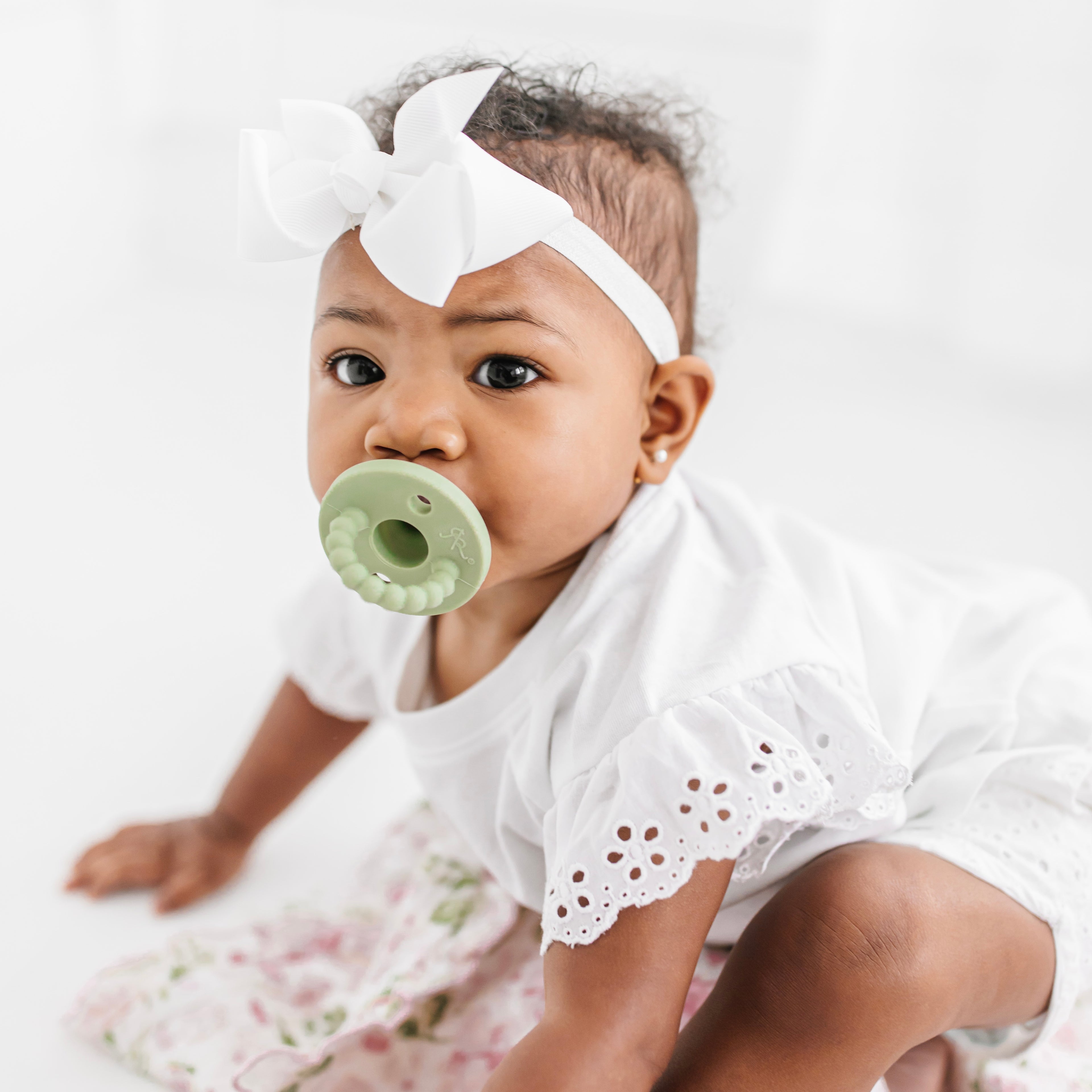 Baby sucking on a pacifier 