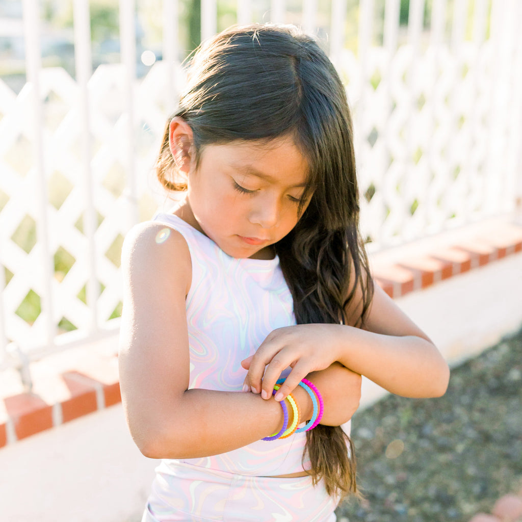 Child wearing the Rave Cutie Bracelets.