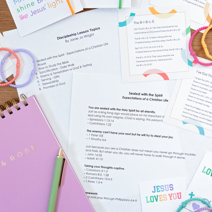 Discipleship lesson topics with a notebook and pen on a wooden surface
