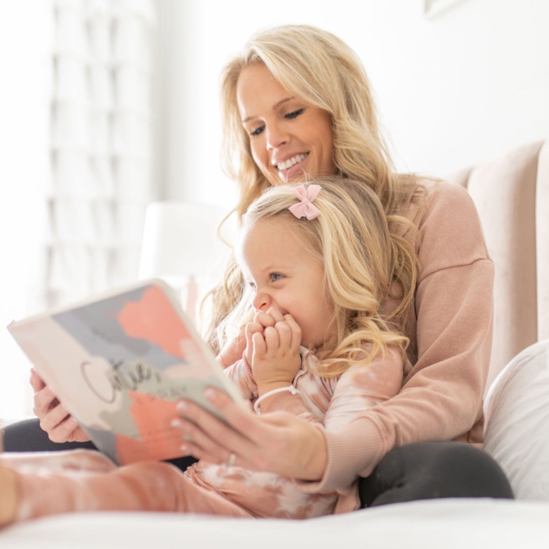 Lindsey reading Cutie, I Pray to her youngest daughter Charley. 