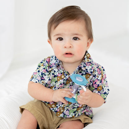 Baby playing with a gear teether toy