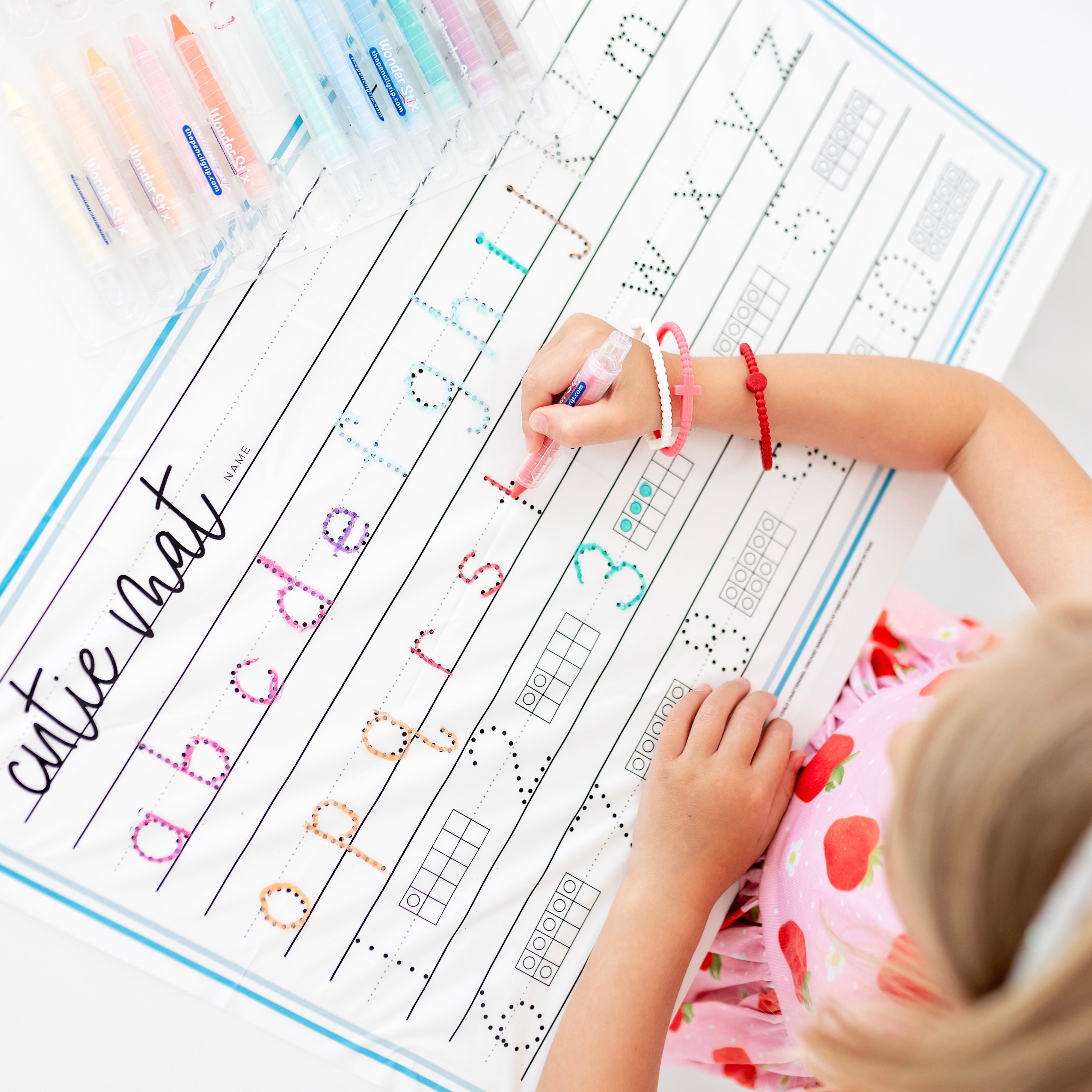 Girl tracing on the Cutie Mat.