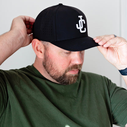 man wearing a JC hat