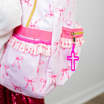 cross charm on a backpack