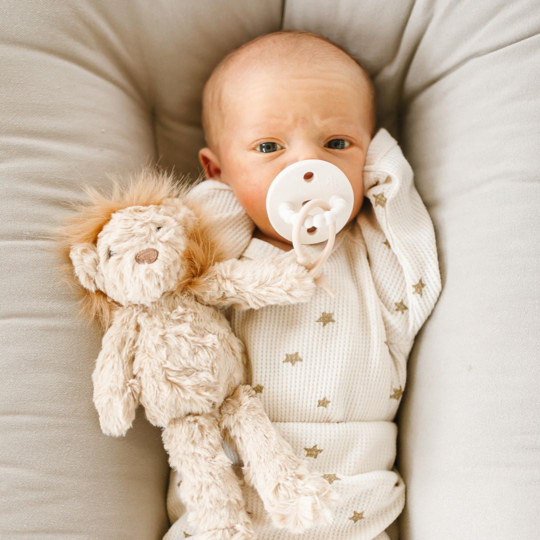 Baby using a White Cutie PAT attached to a Lion Cutie Cuddle.