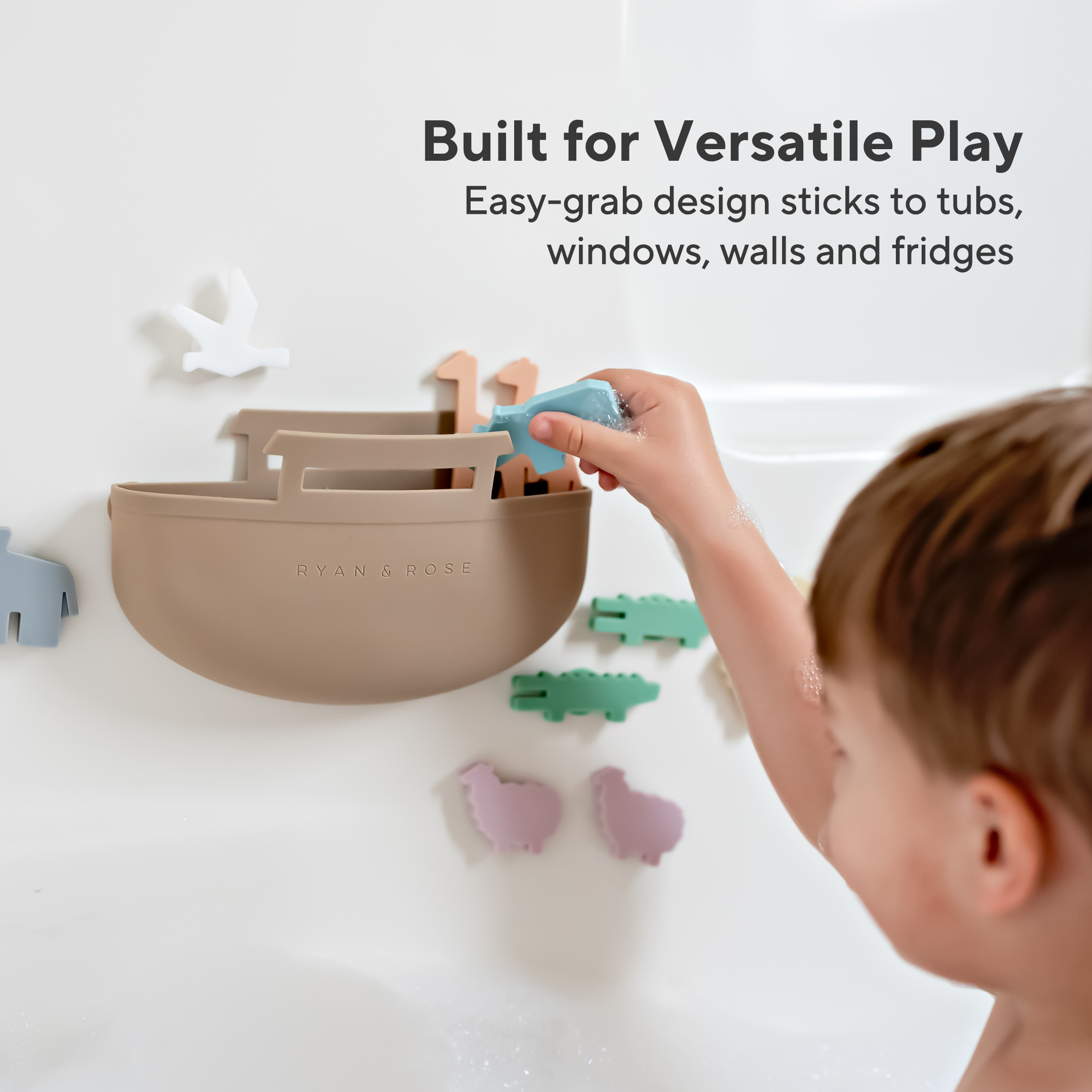 Child interacting with a wall-mounted toy organizer with various animal-shaped toys on a light background.