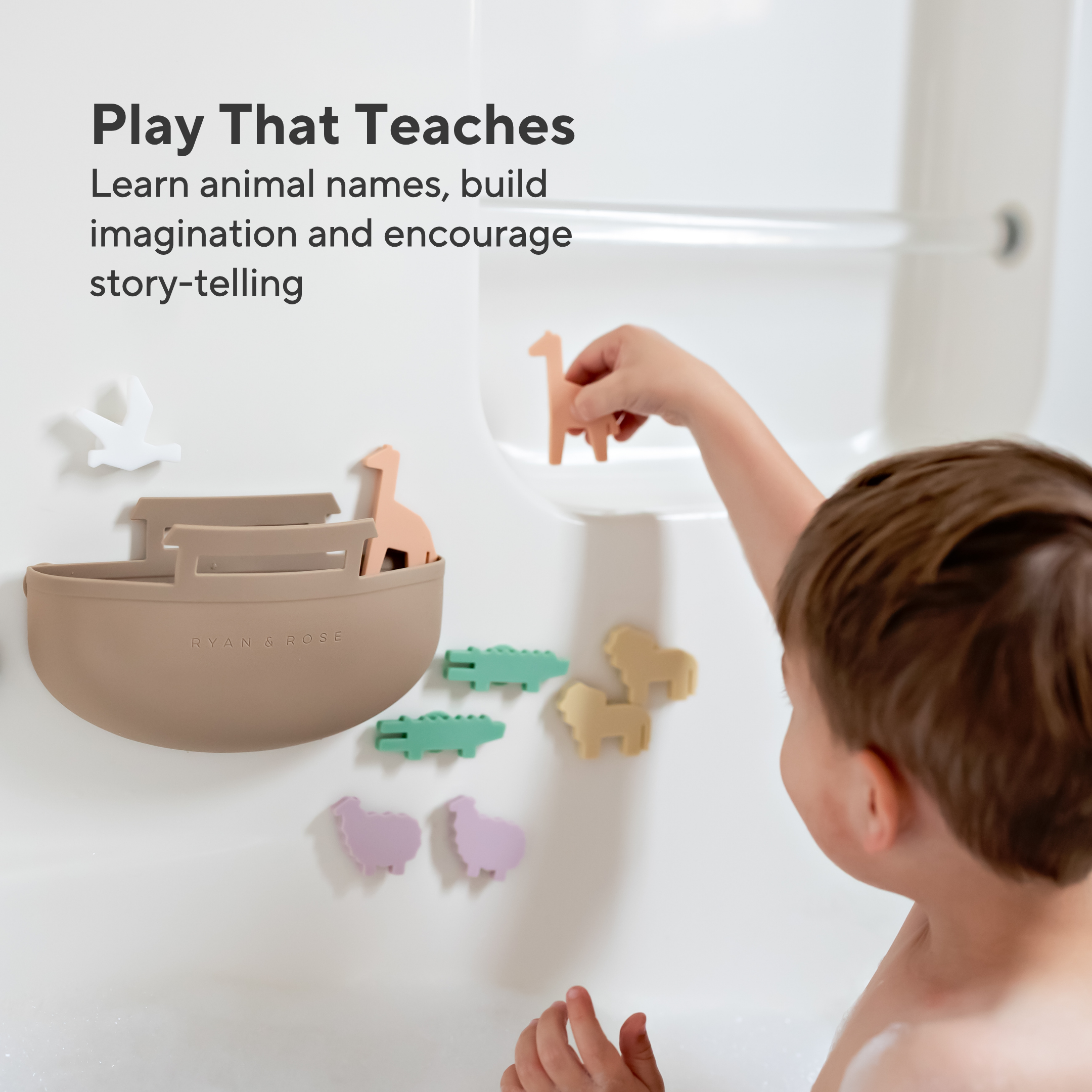Child playing with educational animal toys on a white surface