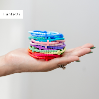Hand holding colorful beaded bracelets with &