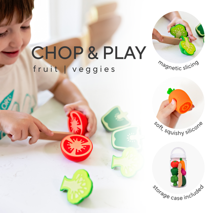 A child is playing with colorful silicone fruit and vegetable chopping toys on a white table. The set includes sliced tomato, carrot, and other vegetable pieces, with circular inset images showing magnetic slicing, squishy silicone texture, and a storage case.