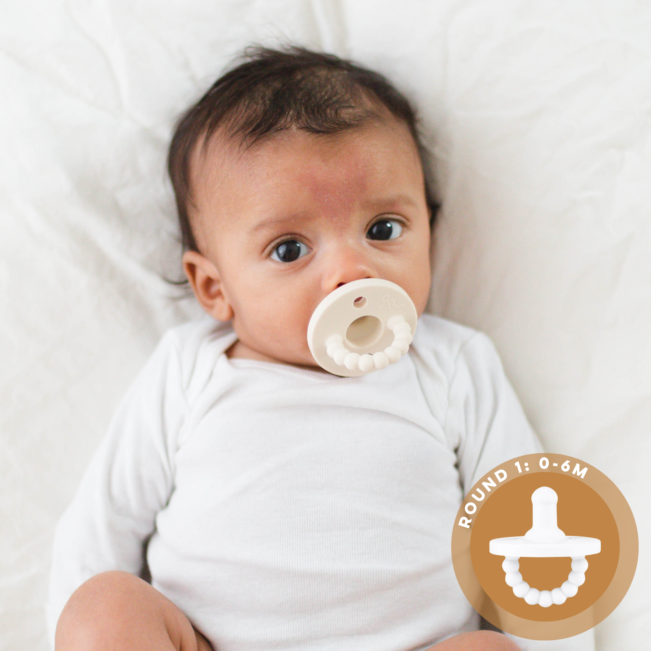Baby with Round 1 pacifier 