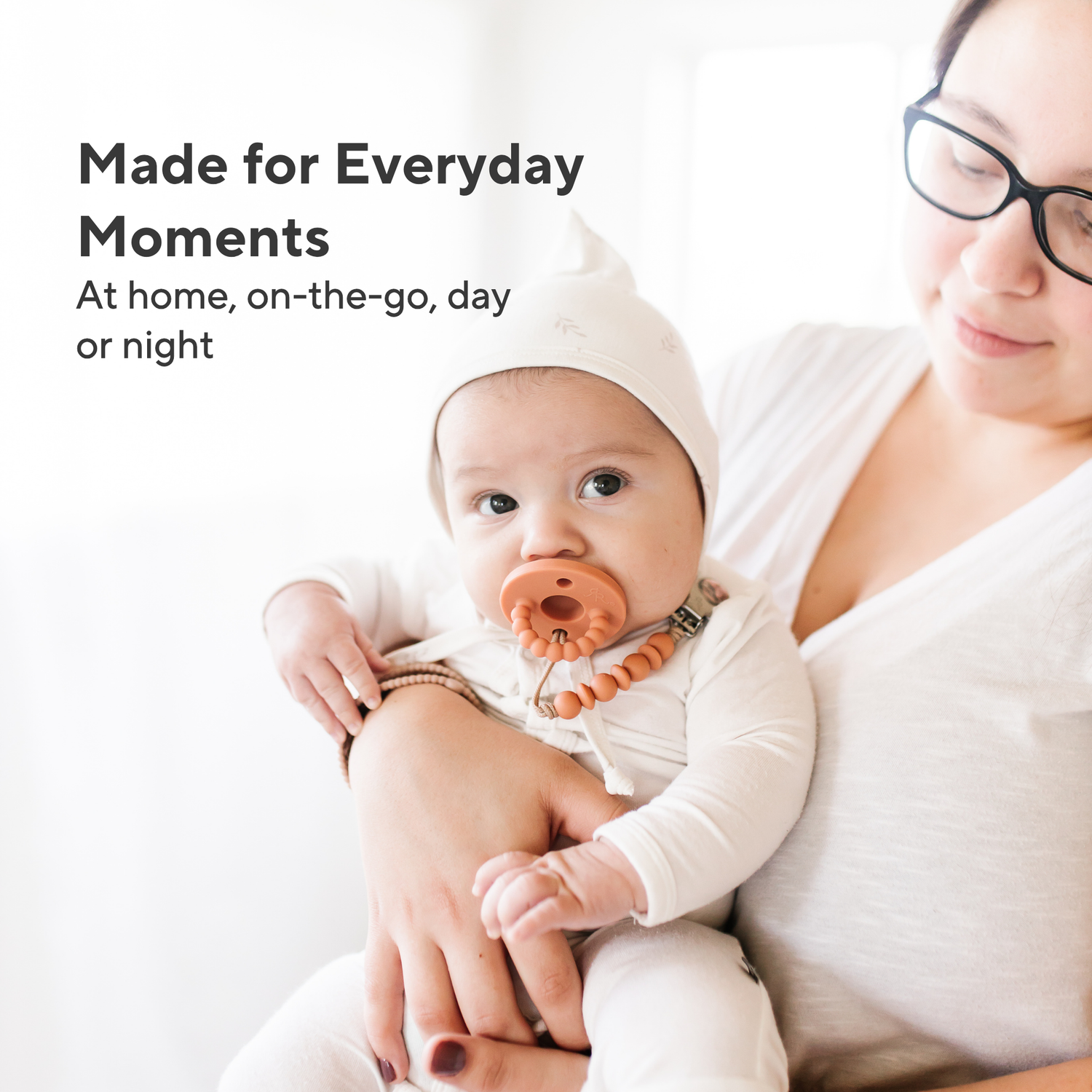 Woman holding a baby with text &