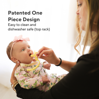 Baby being held by a woman while wearing a floral outfit and teething ring, with text about product features.