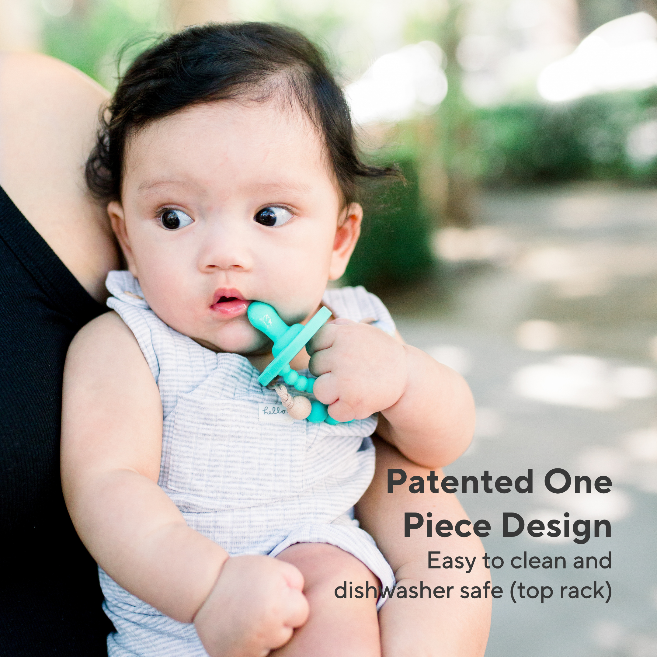 Baby holding a blue teething ring with text about product features.