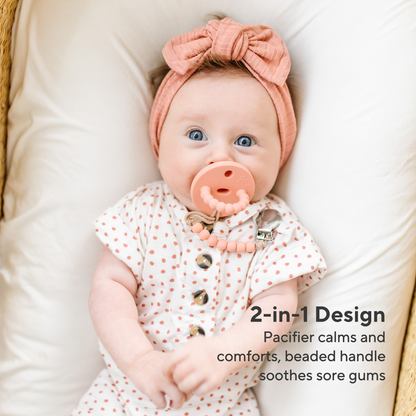 Baby wearing a pink pacifier and headband with text about product features.