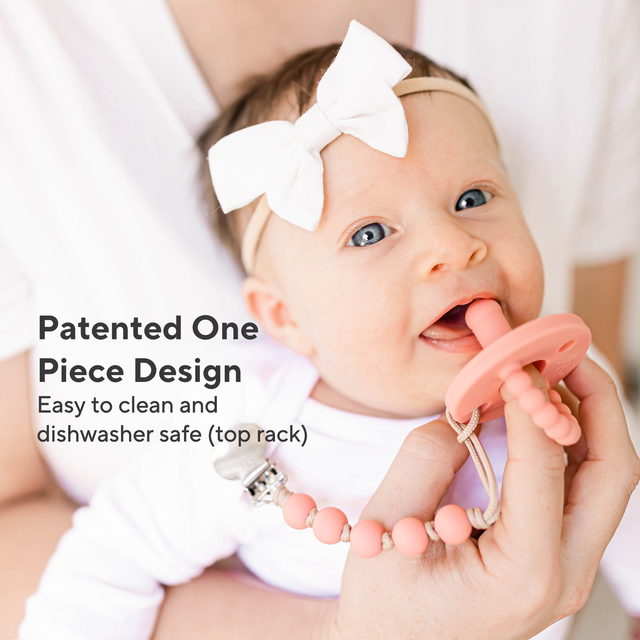 Baby holding a pink teething ring with text about its design and safety features.