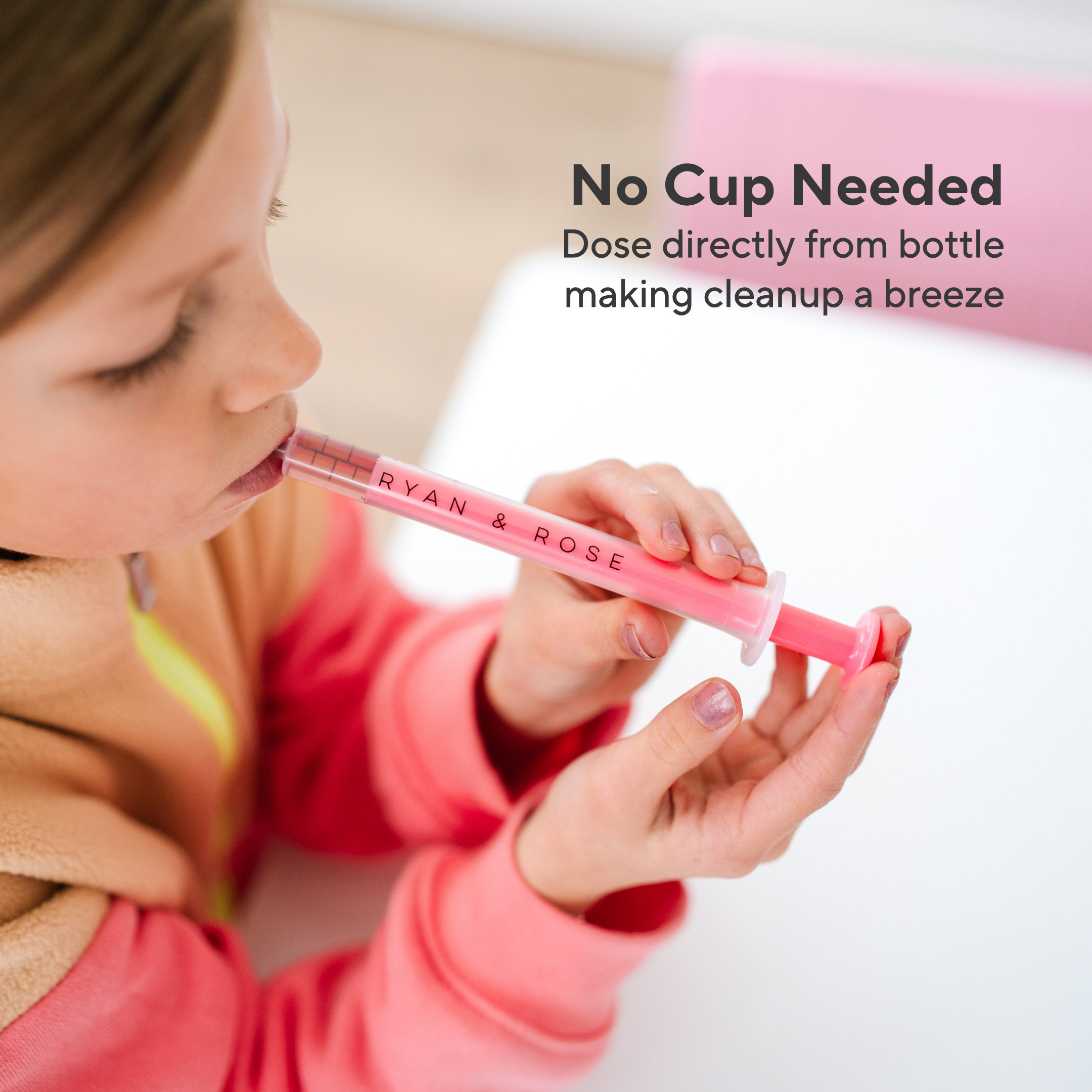 Child using a pink dosing pen with text about no cup needed for cleaning.