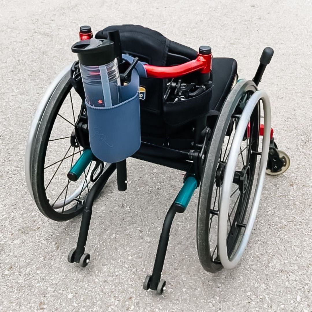 Cutie Holder attached to a wheelchair holding a water bottle.