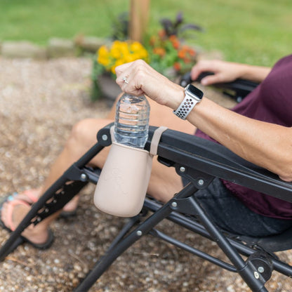 Cutie Holder attached to a lawn chair holding a water bottle.