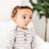 Baby using the Libby Cutie Clip attached to a Cutie PAT. 