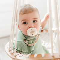 Baby using an Ella Cutie Clip attached to a Cutie PAT Flat.
