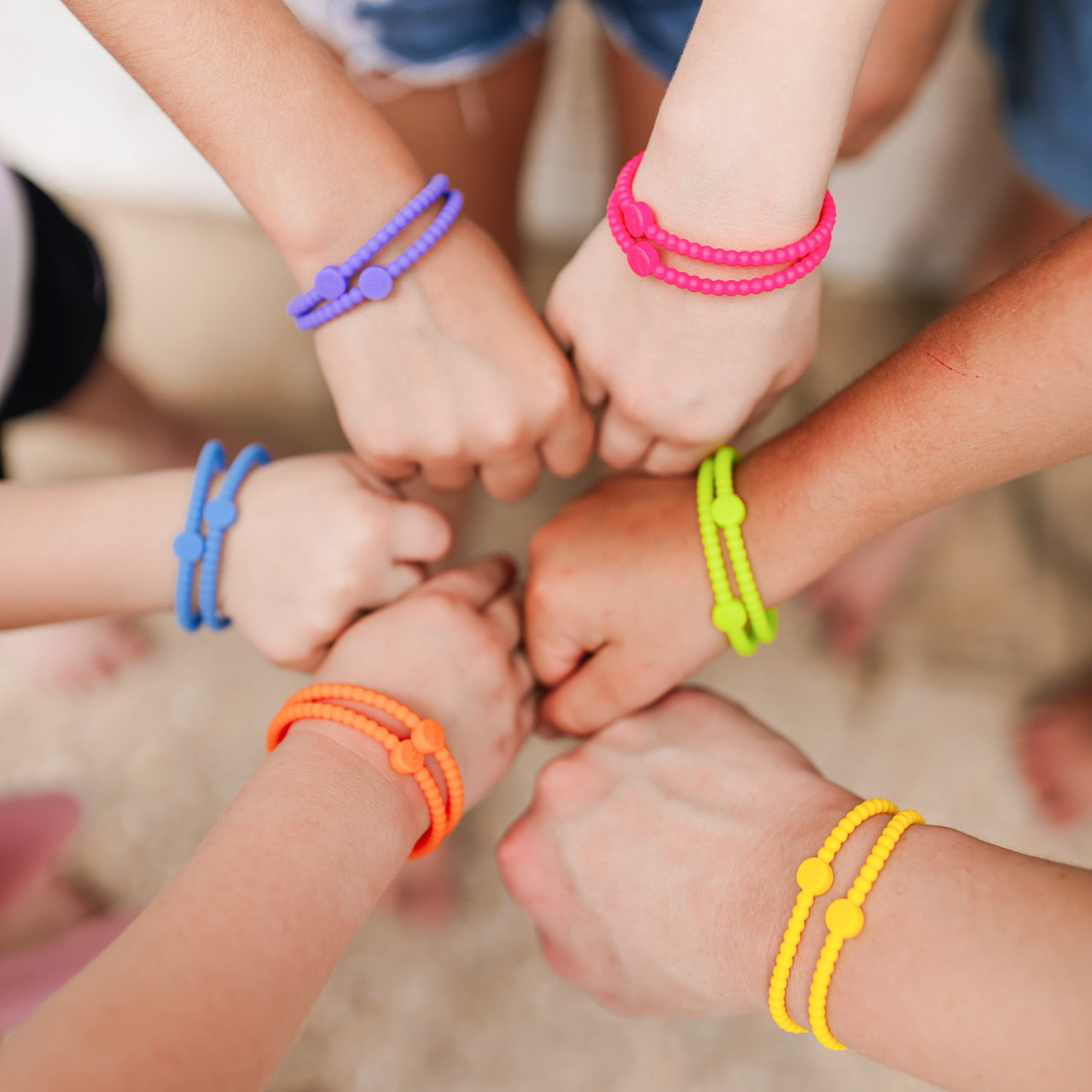 A group of children wearing the Summer 2020 Cutie Bracelets.