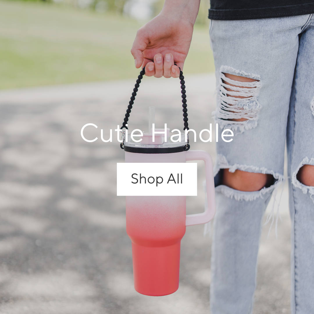 Girl holding Cutie Handle attached to a water bottle.