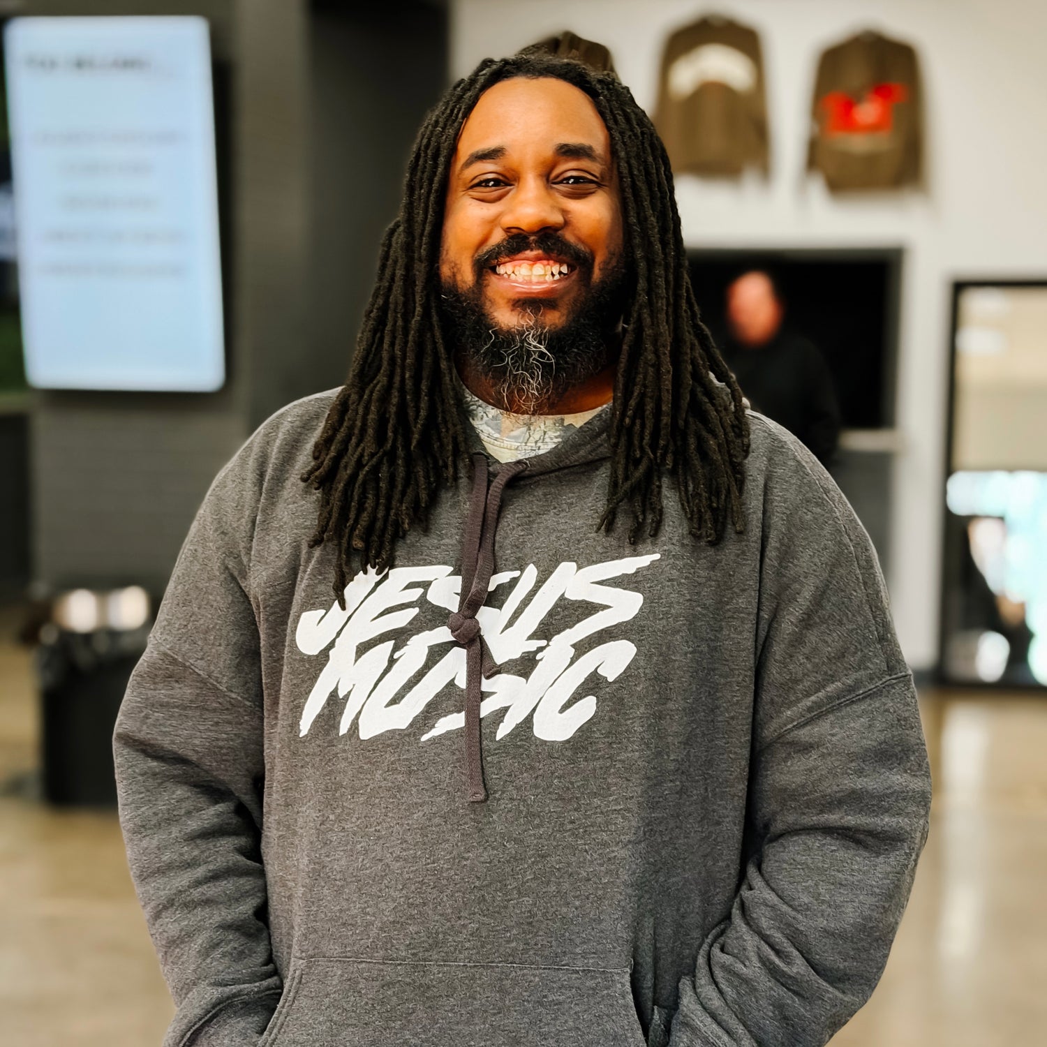 Man wearing a gray hoodie with &