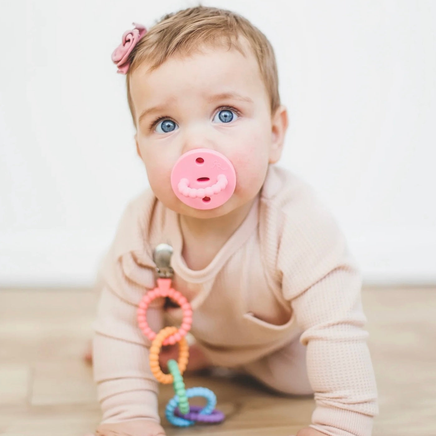 Baby with pacifier and Cutie Clinks